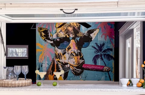 Grab a drink at the Coast & Palms bar—where the flip-up window is open and Tango, the legendary cigar-smoking giraffe, keeps watch.