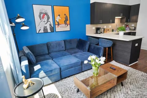 Spacious, cozy living room with plush seating, natural light, and modern décor — perfect for relaxing.