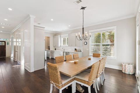 Gather around this elegant dining table where your group can share memorable meals in this bright, open-concept space.
