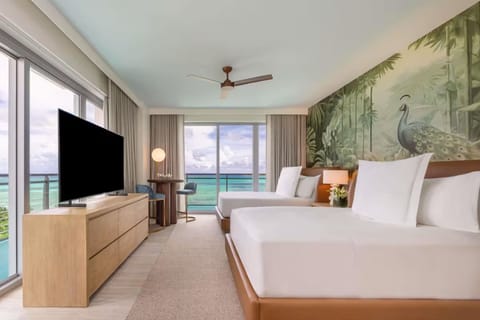 Wake up to turquoise water views from plush, inviting beds.
