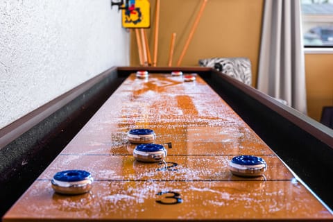 Tabletop shuffleboard with premium pucks and scoring. High-stakes fun is just a slide away in this dedicated recreation zone.
