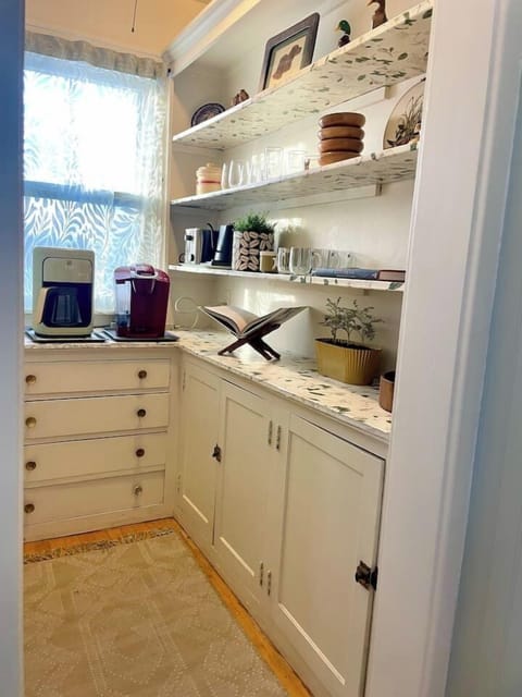 Cozy coffee station featuring a Keurig, drip coffee maker, toaster, and electric kettle—perfect for slow mornings.