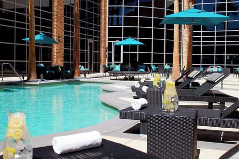 Dive into sunshine by the sparkling pool with plush loungers.