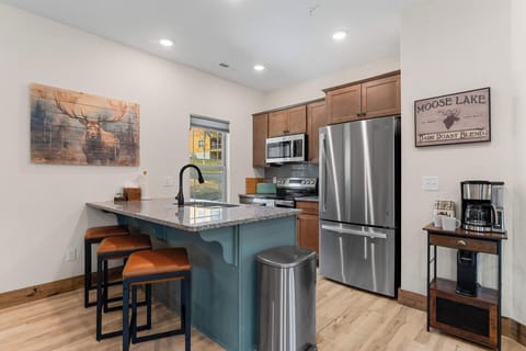 Have a conversation with the cook while sitting at the kitchen counter stools.