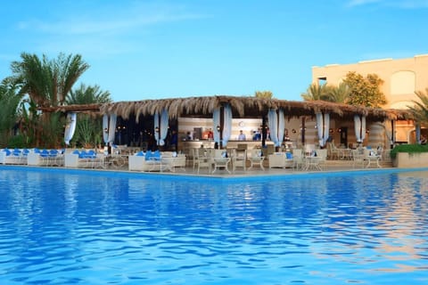 Sip cocktails poolside while the sun sparkles on water.
