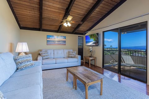 Relax in your ocean-view living room with plush seating, and stunning blue waters stretching through your private balcony.