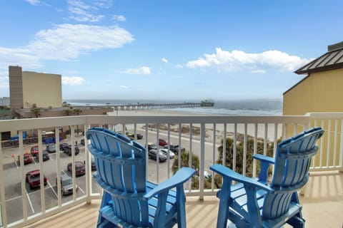 Relax in your private balcony chairs while enjoying stunning ocean views and the historic pier stretching into endless blue waters.