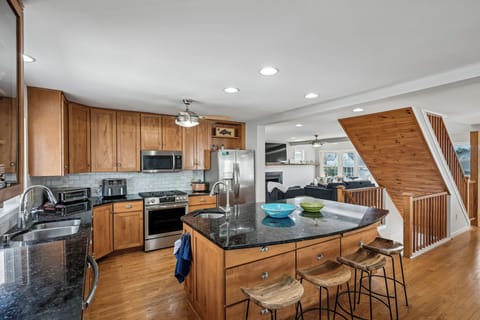Your fully equipped kitchen features granite countertops, stainless steel appliances, and a breakfast bar where you can start your mornings with coffee.