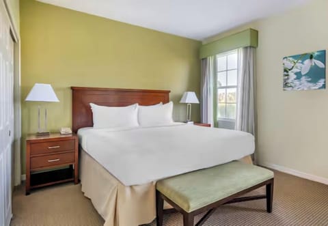 Relax in a classic, spacious bedroom with soft lighting.