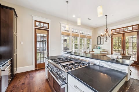 You'll love cooking in this elegant kitchen with its spacious island, professional-grade gas range, and abundant natural light streaming through beautiful windows.