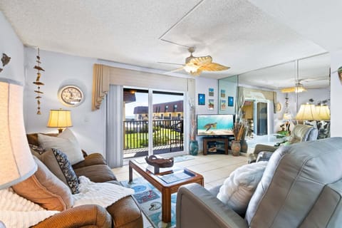 Bright & airy living room with sliding glass doors that lead to a private balcony