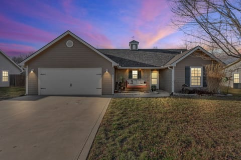 Covered front porch swing with zero-entry access and driveway parking.