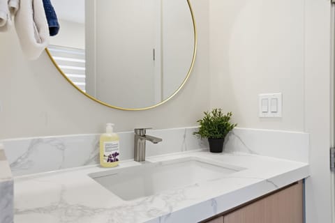 Sink is located between bathroom and kitchenette.