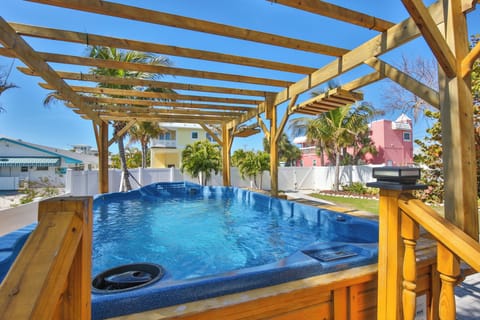 Soak in your private hot tub under the tropical sun, surrounded by swaying palms and colorful Caribbean architecture.