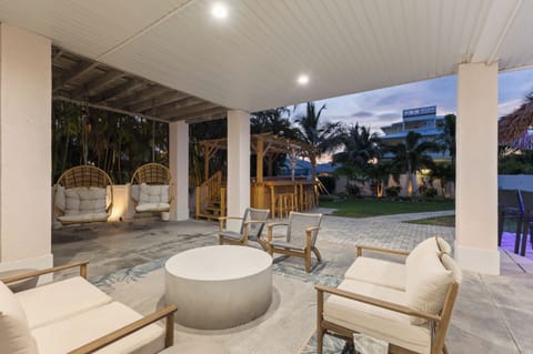 Unwind in your private covered patio with swinging egg chairs and tropical views—perfect for evening conversations under the palms.