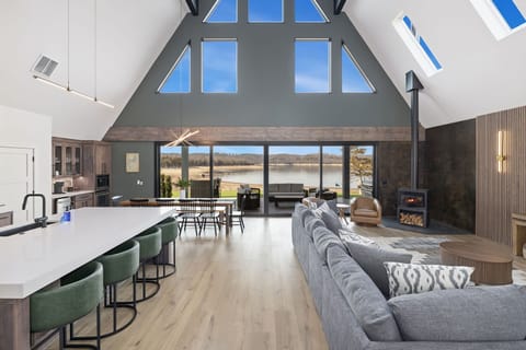 Inside you'll love the open concept living space and kitchen area in the center of the A Frame. This is entire space is flooded with natural light and boasts gorgeous views of Beaver Lake.stunning water views.