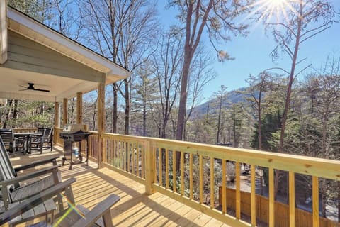 Spacious back deck with rocking chairs, outdoor dining table, and peaceful North Georgia mountain views 🌄