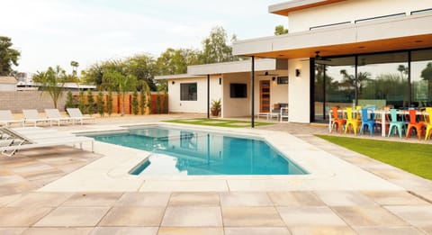 Backyard with Pool, Lounge Chairs, and Covered Patios