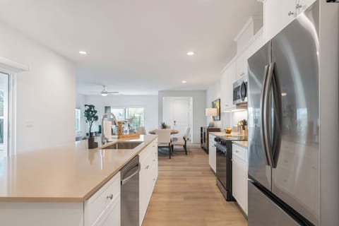 Modern stainless steel appliances and designer backsplashes elevate every meal prep.