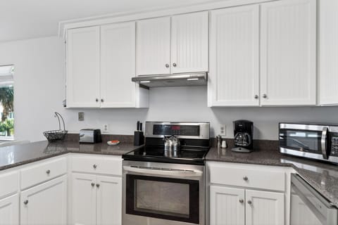 Cook with ease in the clean, coastal kitchen—full-size appliances and plenty of counter space for prep + snacks.