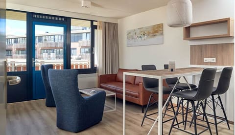 Unwind with sunlit lounge seating and easy balcony access.