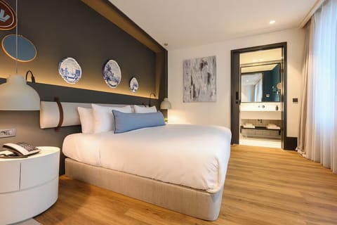 Unwind in a stylish sanctuary with a view into the ensuite.