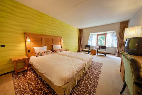 Unwind in a bright twin room with plush bedding.