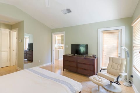 Serene bedroom with TV, lounge chair, and sunshine made for lazy mornings. Zzz!!