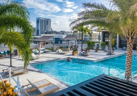 Fort Lauderdale luxury rooftop pool with cabanas, lounge areas, and city skyline views minutes from Las Olas.