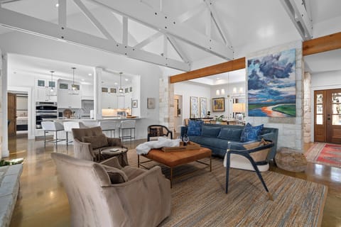 This is the living room at Casa Colina open, airy, and designed to bring everyone together. The kitchen flows right into the living space so nobody misses a moment. Whether it's morning coffee or late night conversations, this room holds it all beautifully