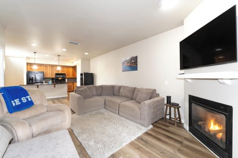 Cozy up on the couch next to the fireplace. | Main Level