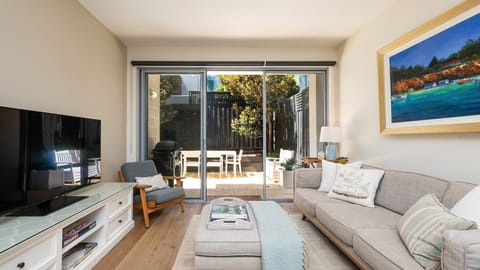 Light, bright living space with large glass sliding doors onto courtyard