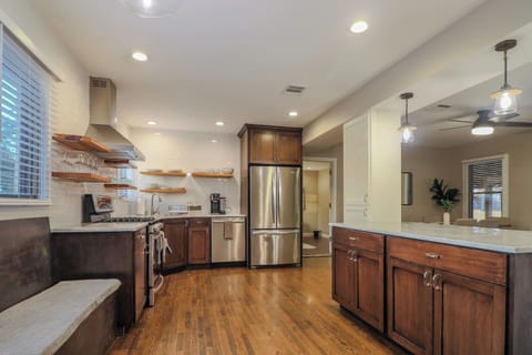 Bright kitchen with full-height subway tile, stainless steel appliances, gas range with hood, and a built-in breakfast nook. Fully stocked with cookware, utensils, and a Ninja dual coffee maker for pods or ground coffee.