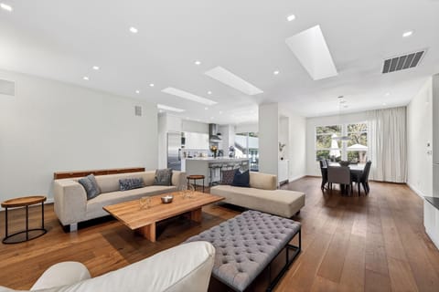 Sophisticated living space with vaulted ceilings, sleek fireplace, and curated modern furnishings designed for effortless relaxation.