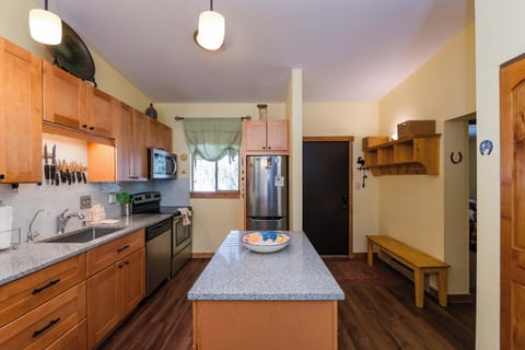 Your spacious kitchen features warm wood cabinets, granite counters, and a large island perfect for preparing meals together.