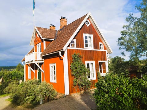 Charming red and white holiday home with lake view near Vimmerby House in Kalmar County, Sweden