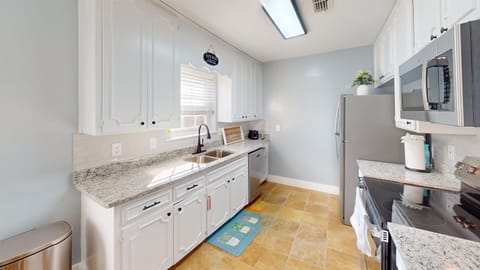 The kitchen is fully equipped wit a stove, dishwasher, refrigerator/freezer w icemaker, microwave and cooking utensils, dishes and silverware and cookware