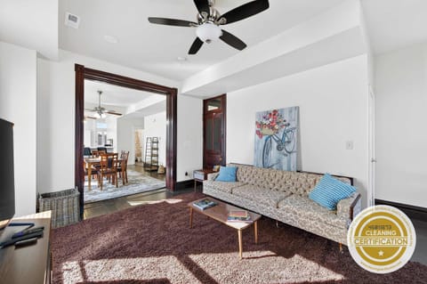 An airy layout with classic architectural charm flows seamlessly from the cozy lounge into the dining space—perfect for entertaining or quiet nights in.