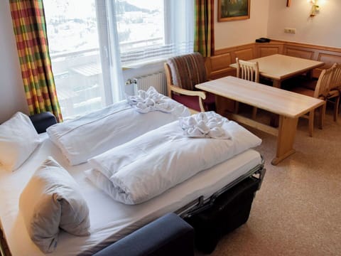 Furniture, Chair, Living Room, Bed, Houseplant, Bed Frame, Kitchen & Dining Room Table, Hotel, Window Treatment, Coffee Table