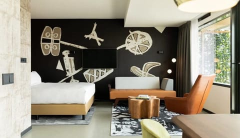 Unwind in a design-forward studio suite with cozy lounge seating.