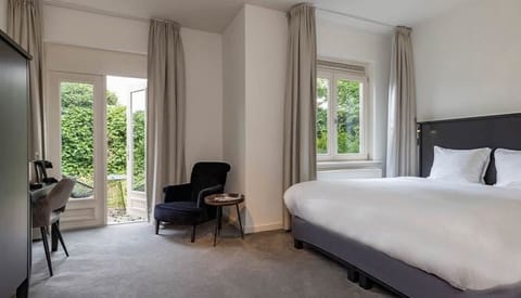 Unwind in a serene bedroom with leafy views and soft carpets.