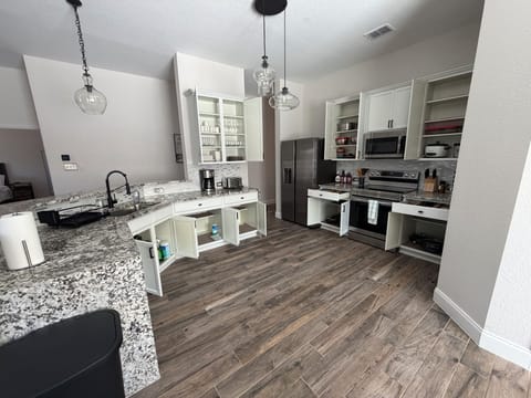 Fully stocked kitchen with utensils, coffee & rice maker, blender & toaster