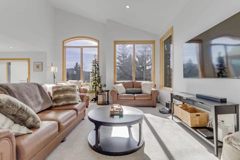 Sink into plush leather sofas while snow-capped mountains frame your perfect winter retreat through expansive windows.