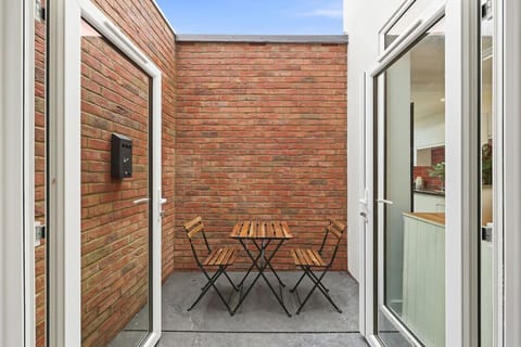 Bedroom 1 boasts its own private patio with outdoor seating.