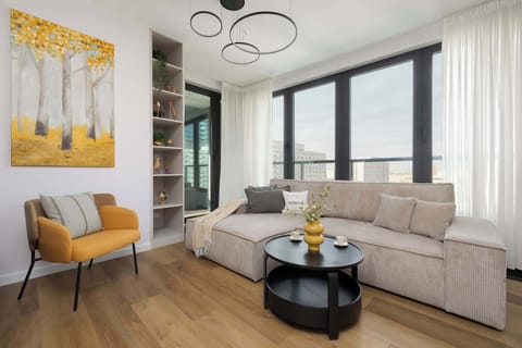 Relax in the stylish living room with a comfortable sofa and modern decor.
