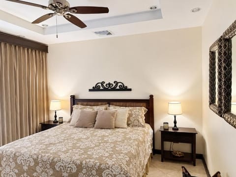 Relaxing bedroom with warm lamps, soft bedding, and neutral décor.