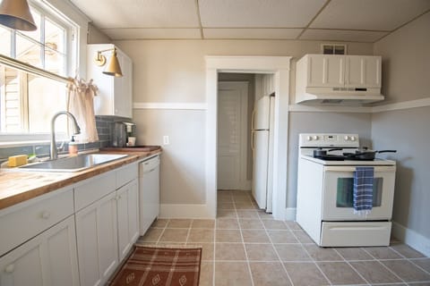 Kitchen equipped with modern appliances and essential cookware.
