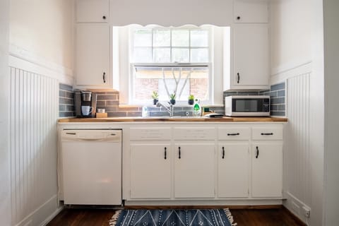 Sunny kitchen with coffee maker, toaster, and microwave to start your mornings right.