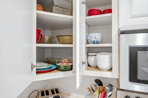 Modern, fully equipped kitchen with stainless appliances and stacked washer/dryer