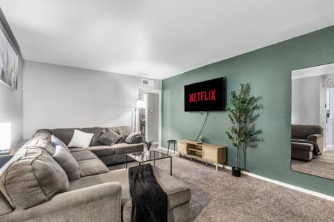Spacious and inviting living area with comfortable seating and a smart TV, perfect for relaxing after exploring Arlington or attending events at AT&T Stadium.